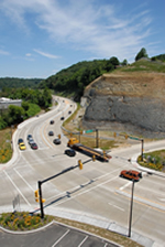 Aerial photo of the signalized intersection. State Route 8 curves around the rock cut slope to approach the intersection.