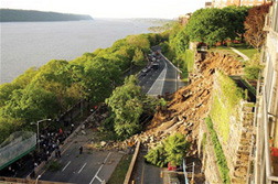 A retaining wall that failed in New York City. The wall collapsed onto the Henry Hudson Parkway in 2005. Soil, fallen trees, and other debris are strewn across the roadway.