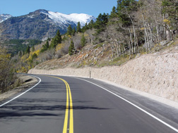 A stone facing retaining wall next to a roadway in Colorado.