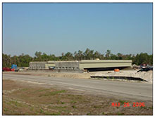 Two new bridge spans are shown in a staging area where they were constructed.