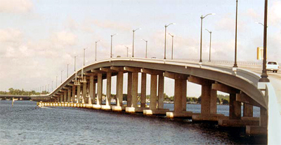 The figure is a photo of the Edison Bridge (Photo courtesy of Florida DOT). It is a multi-span viaduct over a cove that was built with precast concrete pier columns and caps.