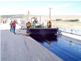 The bottom layer of hot bituminous pavement (HBP) was placed on the ABC, followed by geotextile with a heavy tack coat for waterproofing and abutment reinforcement.