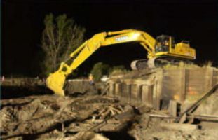 Existing timber pile piers are broken off, abutments and wingwalls are torn out.