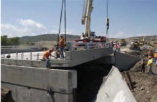 The outside girders were precast with the curb in place and the bridge rail was attached beforehand.