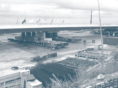 Photograph showing SPTMs lifting a two-span bridge crossing Amsterdam's A4/A5 espressway off temporary supports from the side.