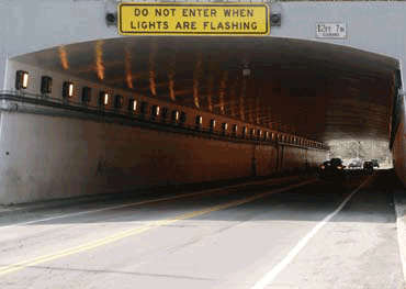 Tunnel with sign that says do not enter when lights are flashing