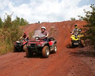 Three  people riding OHVs in a nature setting