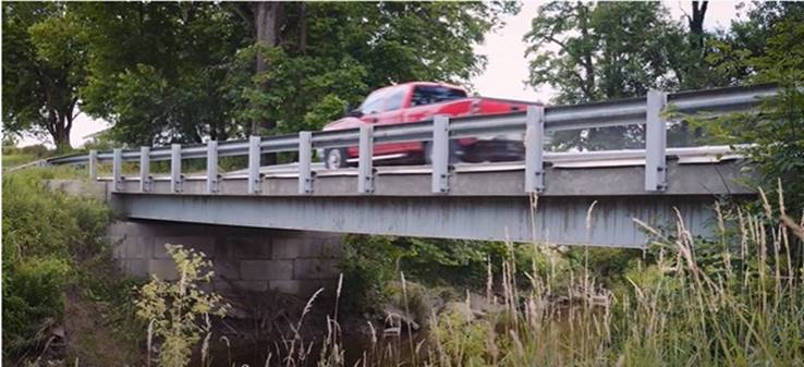A red pickup truck crossing a bridge in Muskingum County, Ohio