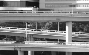Cameo: Three elevated, near parallel, grade separated ramps crisscross allowing traffic to flow without merging.