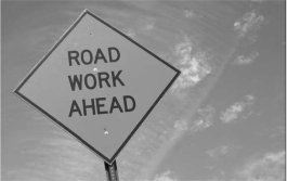 Cameo: 'Road Work Ahead' sign set against a blue sky.