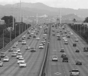 Cameo: Straight on shot of 10, well traveled lanes of Interstate Route H-1 on Oahu.