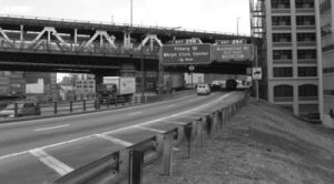 Cameo: An embankment to the right of a four lane urban highway.