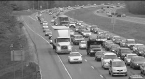 Cameo: Vehicle congestion concentrated in one direction of an eight lane divided highway.