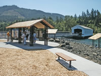 Information kiosk with covered bridge in background. The Lowell Covered Bridge project brings together different elements: traveler services, history, local recreation, and education on forests as renewable resources.