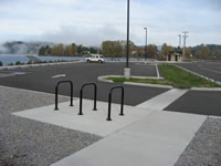Parking area with lake views and restroom in background. Public restrooms, picnic facilities, walkways and parking facilities to accommodate cars, recreational vehicles, busses, and bicycles were constructed.