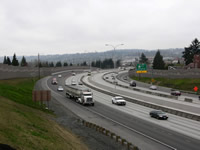 Photo of the I-5 freeway with noise walls on both sides.