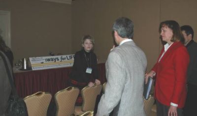 Priscilla Tobias (left) discussing her state's traffic safety programs with several audience members