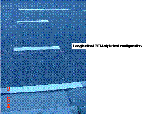 This picture shows a view of a small segment of the roadway taken from the road shoulder with expeirmental markings. It shows four skiplines, longitudinally placed on the roadway, where the two outermost ones lay on the edges of a 12-feet lane, and the middle two are spaced equally in between, where each one is approximately on a wheel track.