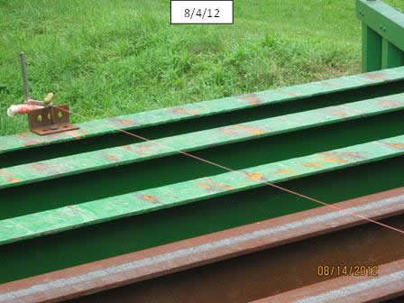 Figure 12. Photo. Stringline girders to determine if haunch corrections are needed. Note that the A588 stringer has replaced one that was corroded due to the previous open grating.