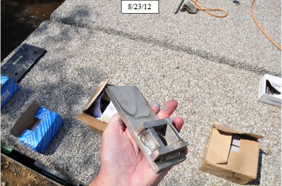 Figure 18. Photo. Secure panels with stainless steel clips and expansion bolts. Clip is shown.