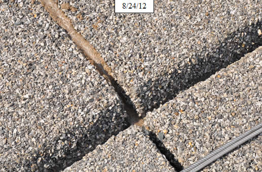 Figure 22. Photo. Install transverse rebar and epoxy grout in field joints. Thirty-six-inch #3 stainless rebar provides a positive tie across the centerline joint.