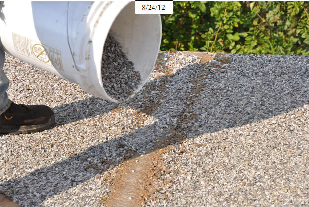 Figure 23. Photo. Embed clean, dry, angular aggregate on the surface of the epoxy-grout field joints.