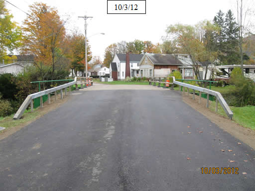 Figure 31. Photo. Install bridge railing posts, rails, and approach railing. 
