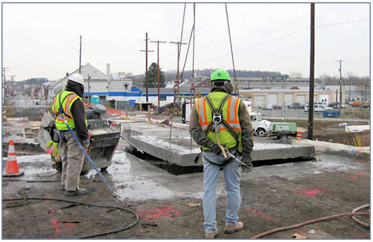 Photo showing the removal of saw cut section of bridge deck