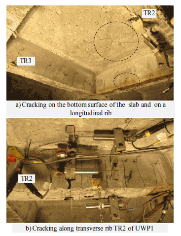 Three to four hairline cracks were observed on both transverse ribs (TR1, TR2 and TR3) and longitudinal ribs (LR1 and LR2) of panel UWP1. a.) A hairline crack was seen on the bottom surface of UWP1 (between ribs TR2 and TR3) at the peak load.