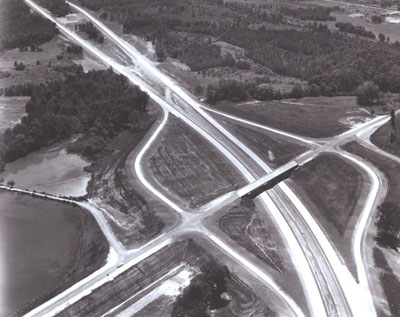 Alabama - Separate roadways fitted into the landscape, as seen beyond the diamond interchange, are typical of design on Interstate Route 59 between Argo and St. Clair Springs.  (Not yet in use when photographed.)