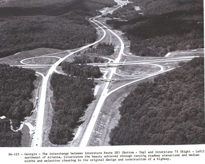 Georgia - The interchange between Interstate Route 285 (bottom & top) and Interstate 75 (right & left) northwest of Atlanta, illustrates the beauty achieved through varying roadway elevations and median widths and selective clearing in the original design and construction of a highway.