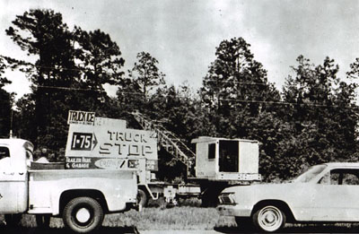 Georgia - Highway Department maintenance forces are shown removing a billboard erected in violation of State law controlling outdoor advertising from alongside Interstate 75 in south Georgia during a May, 1965, clean-up of unauthorized signs.