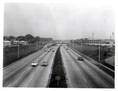 Interstate 94 (Edens Expressway) thru commercial and residential area, also showing depressed section and frontage road left.  Looking North into Foster Ave.  From Railroad overpass, Chicago, Illinois.