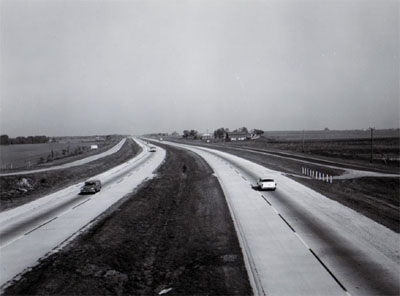 INTERSTATE 55 Looking north showing frontage roads, 48 foot depressed median, 10 foot gravel shoulders and 24 foot concrete pavement.  Miles north of US 52