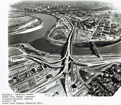 Kansas - Interstate Route 70 links the two Kansas Cities, crossing the Kansas River on the old and new Intercity Viaducts.  (The new structure was carrying all traffic while the old one was being re-decked.)  The Kansas City, Mo., central business district, looming in the distance above, is shown close up below, served by the Innerloop section of I-70.  (Construction was underway at the time of this phrotograph.)