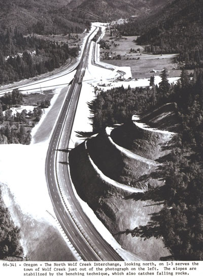 Oregon - The North Wolf Creek interchange, looking north, on I-5 serves the town of Wolf Creek just out of the photograph on the left. The slopes are stabilized by the benching technique, which also catches falling rock.