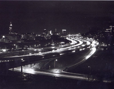 Washington- Interstate 5 in downtown Seattle.  At top left is the Smith Tower. At center top is pictured the top of the world famous Space Needle, focal point of the 1962 World's Fair.