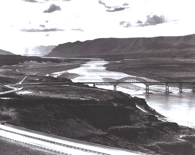 Washington - Interstate Route 90 slopes down from the foreground to cross an impressive structure over the Columbia River near Vantage.  The old bridge at this location was removed, since it would have been submerged after completion of Wanapum Dam downstream.  The public utility district which built the dam contributed $4million toward the new bridge.