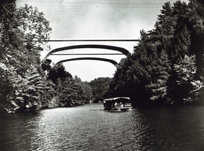 These tow pairs of twin bridges on Interstate Route 90 in Wisconsin Illustrate both the functional grace and the diversity of design with which bridge builders fit structures to location needs.  The girder bridges supported on piers cross the Wisconsin River; the steel arches span Mirror Lake near the Wisconsin Dells.  These bridges are part of a 55-mile, $32 million section of Interstate 90 between Madison and the Dells, opened to traffic in October 1961.