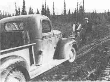 Two men pulling a truck
