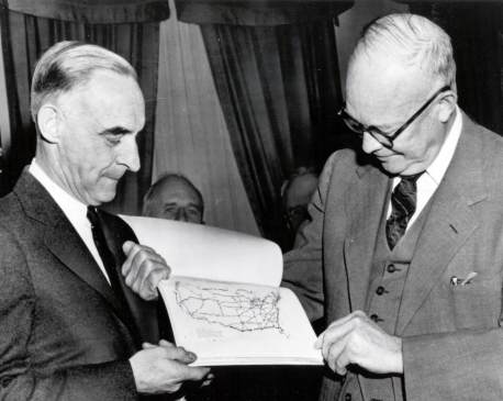 General Lucius D. Clay (left) shows President Dwight D. Eisenhower a detail from the Clay Committee's report.  Photo courtesy of Eisenhower Library