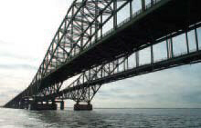 Page 7 Photograph: View of a portion of a steel truss bridge spanning a river.