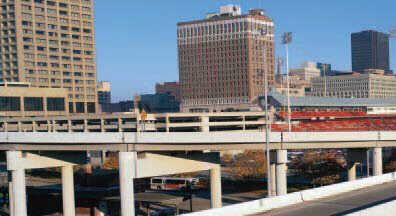 Page 14 Photograph: First half of two-page panoramic photograph of an elevated highway section in an urban area.