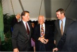 Former Secretary of Transportation Jim Burnley talks with Vice President Al Gore and his father, Al Gore, Sr., after the ceremony.