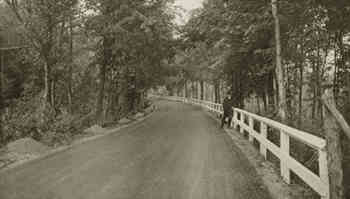 marquette-negaunee road in marquette county, mich., was called lovers' lane. this road is water-bound, trap-rock macadam with limestone binder, bituminous surface treated.