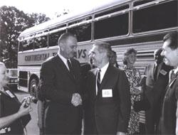 President Lyndon Johnson speaks with Federal Highway Administrator Rex Whitton before he boards the bus for the Landscape-Landmark Tour.  On the right, Deputy Federal Highway Administrator Lawrence Jones looks on.