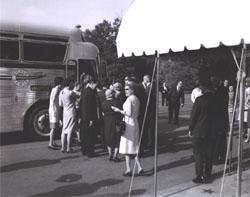 President Lyndon Johnson looks on (right) as participants in the Landscape-Landmark Tour enter chartered tour bus.