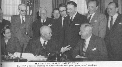 President Eisenhower talks to Harlow H. Curtice (seated on right), Chairman of the President's Committee for Highway Safety.  Other members include newspaper executive William Randolph Hearst, Jr., (back row, second from right) and the only woman on the Committee, Mrs. Raymond Sayre of Iowa.