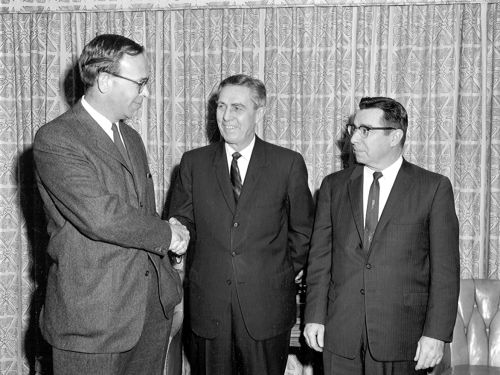 Administrator Rex Whitton (center) and Chief Engineer Frank Turner (right) congratulate Lowell Bridwell following his swearing in as Acting Deputy Federal Highway Administrator on January 20, 1964.  Bridwell, a former journalist specializing in transportation, would become the Deputy Under Secretary of Commerce for Transportation (Operations) on July 2, 1964, and replace Whitton as Administrator on March 23, 1967.