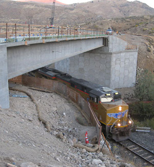 Photo of train under a bridge